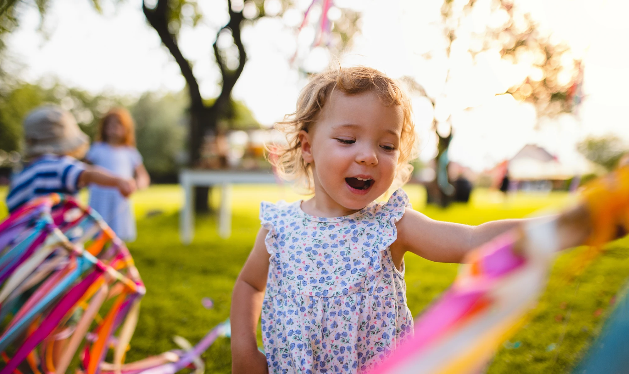 smiling girl playing with ribbons