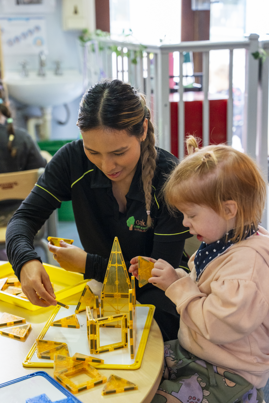 a toddler playing with her educator