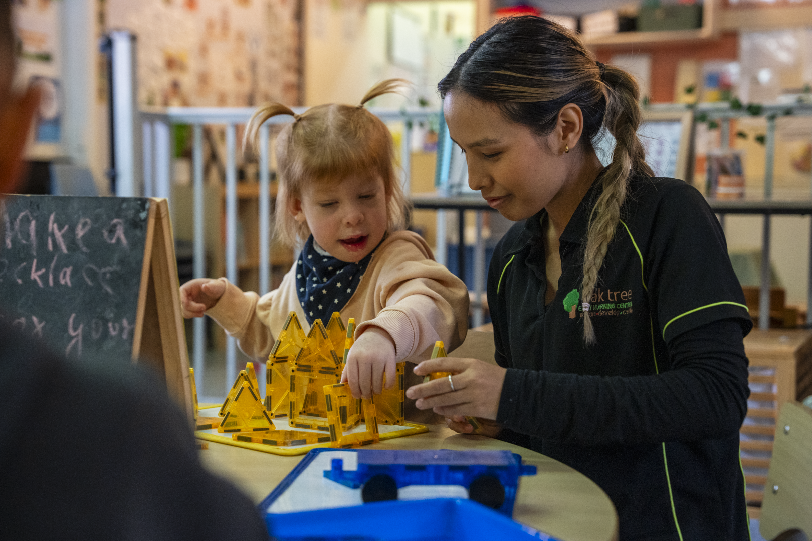 a child playing with the educator